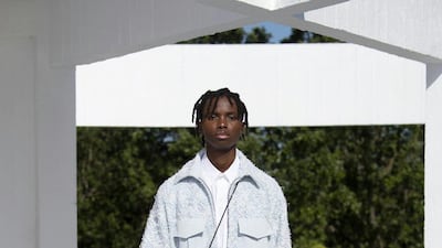 An icy blue jacket made from a richly textured fabric, and offset with plain pockets. Courtesy Qasimi