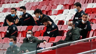Cristiano Ronaldo, right, watches the match from the stands. AP