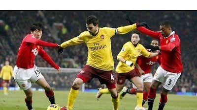 The championship is now realistically between Arsenal, above in yellow, and Manchester United, in red, but Andrew Cole still believes that it will be United and Sir Alex Ferguson, their manager, who will win the title in May. Dave Thompson / PA