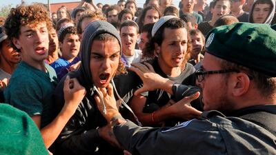 Israeli settlers scuffle with Israeli security forces at Netiv Haavot settlement, near Bethlehem, in the occupied West Bank. Fifteen Israeli settler families are expected to evacuate their homes in this outpost after it was declared illegal by the Israeli High Court. Menahem Kahana / AFP