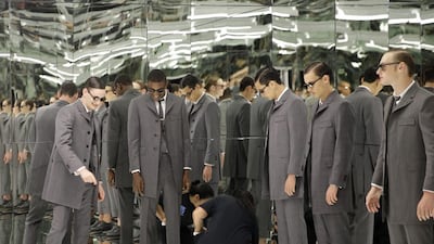 Thom Browne’s collection features sharp grey suits paired with slim-cut cropped trousers. Seth Wenig / AP Photo