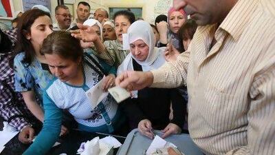 Syrian queue to cast their votes at a polling station in Damascus yesterday but, with all of the opposition groups boycotting the election, Mr Assad is assured of victory.