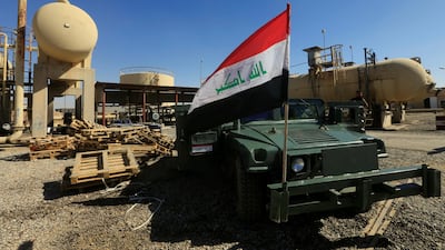 An Iraqi flag is seen on a military vehicle at an oil field in Dibis - an area on the outskirts of Kirkuk - on October 17, 2017, after Baghdad launched a campaign to retake disputed territory from Kurdish forces. Alaa Al Marjani / Reuters