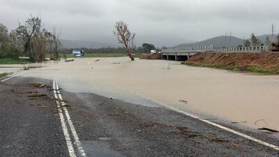 Flood waters submerging part of a highway near the Bowen area in Queensland that was hit by the powerful storm. Handout from Queensland Police Service via AFP Photo