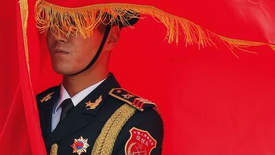 A Chinese People's Liberation Army honour guard member holds a flag during a welcoming ceremony for Spanish King Felipe VI in Beijing. AFP