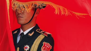 A Chinese People's Liberation Army honour guard member holds a flag during a welcoming ceremony for Spanish King Felipe VI in Beijing. AFP