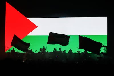 Massive Attack play to tens of thousands of people with a giant Palestinian flag as background at the low carbon music and art festival. Getty Images