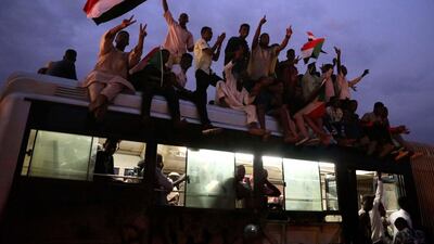Flags are waved as people celebrate after the signature of the power sharing agreement. EPA/MORWAN ALI