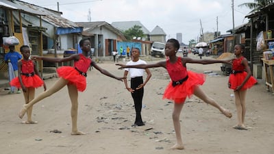 Ballet student Anthony Mmesoma Madu, centre, stands in position as fellow dancers perform in the street in Lagos, Nigeria. AP photo