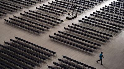 An employee walks between seats ahead of the Siemens company's annual shareholder's meeting in the Olympic hall in Munich, southern Germany. The European champion debate has been driven by the European Commission’s decision to block a rail merger between Siemens and Alstom. AFP