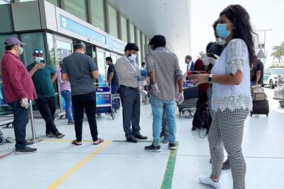 Relatives and friends of passengers outside Terminal 2 as India begins repatriation flights. Pawan Singh / The National