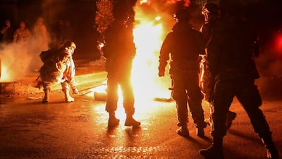 Members of the Lebanese army stand near burning tires during a protest against the lockdown and worsening economic conditions, amid the spread of the coronavirus disease (COVID-19), in Tripoli, Lebanon. Reuters