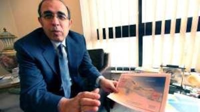 Ibrahim Kamel, the chairman of Kato Investment, holds a map of land he owns next to the proposed nuclear facility in Al Dabaa.