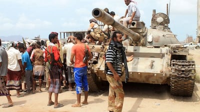 Yemeni members of the southern separatist movement, loyal to president Abdrabu Mansur Hadi, standing next to a tank on June 1, 2015 in Aden’s eastern suburbs. The same day, a UN-chartered ship loaded with humanitarian supplies bound for Hodeidah wasforced to turn back after it was targeted by shelling as it approached Aden. Saleh Al Obeidi/AFP Photo