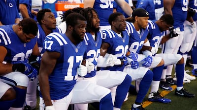 Indianapolis Colts players kneel during the playing of the US national anthem earlier this month. Brian Spurlock / USA Today