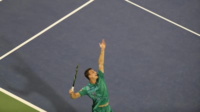 Fucsovics serves the ball to Federer. AFP