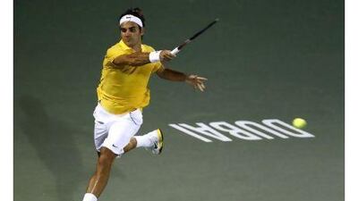 Roger Federer of Switzerland hits a return to Somdev Devvarman of India.