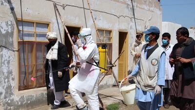 Afghan health workers spray disinfectants at public places in Helmand, Afghanistan. EPA