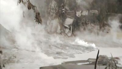 Remains of a bridge on a slope, destroyed by the flowing lava, in the Lumajang district. AP