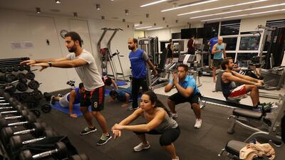 Omnicom Media employees work out at their office gym in Dubai Media City. Pawan Singh / The National