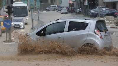 A Palestinian drives his car during a rain storm in Nablus. EPA