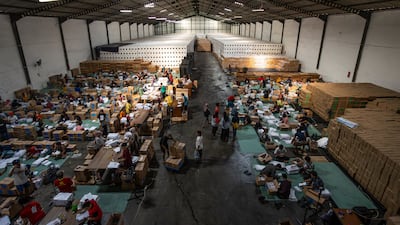 Workers sort and fold ballot papers at the general elections logistics warehouse in Surabaya, Indonesia. Getty Images