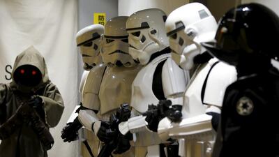 Store staff dressed up as Stormtrooper, Jawa left, and Death Star Gunner right. Toru Hanai / Reuters