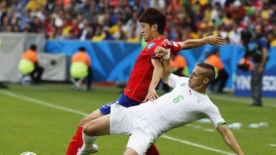 Lee Chung-yong of South Korea in action against Djamel Mesbah of Algeria during their match on Sunday at the 2014 World Cup. Armando Babani / EPA