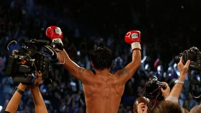 LAS VEGAS, NEVADA - APRIL 09: Manny Pacquiao celebrates after defeating Timothy Bradley Jr. by unanimous decision in their welterweight championship fight on April 9, 2016 at MGM Grand Garden Arena in Las Vegas, Nevada. Christian Petersen/Getty Images/AFP== FOR NEWSPAPERS, INTERNET, TELCOS & TELEVISION USE ONLY ==