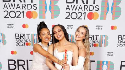 Leigh-Anne Pinnock, Jade Thirlwall and Perrie Edwards of Little Mix pose with their British Group award. AFP