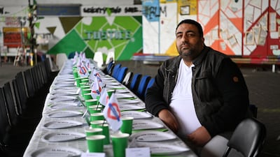 Former Grenfell Tower resident Nabil Choucair, who lost six members of his family in the west London fire, sits at an empty table for victims. PA