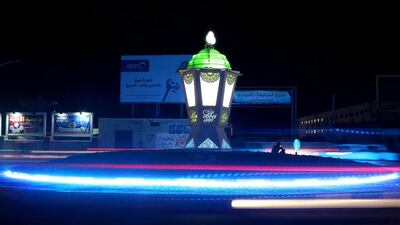 A picture taken with a slow shutter speed shows a view of a large traditional Ramadan lantern, called 'Fanous,' installed at a roundabout in Al Shalihat Square as the traffic flows during the third day of Ramadan, in Gaza City. Mohammed Saber / EPA