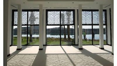 Irregular aluminium screens on the large picture windows provide shade and offer a modern take on ancient Arabic mashrabiya.