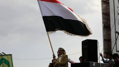 A Houthi supporter waves a Yemeni flag during a protest against Saudi Arabia, in Sanaa. EPA