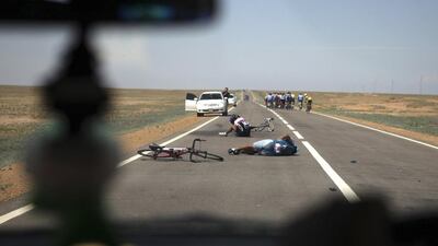 Cyclists lay on the road after crashing as they compete during the 2nd stage of the Tour de Mongolia from Sainshand to Choir. Mareike Guensche / Reuters