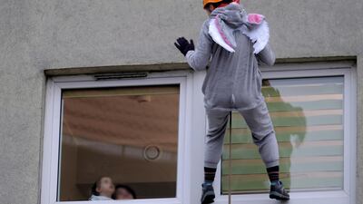 A climber dressed in an animal costume visits sick children at the Department of Paediatrics of the Clinical Hospital in Zabrze, southern Poland. EPA