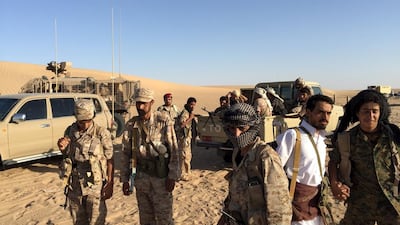 A group of soldiers trained by Emirati and Gulf Arab forces gather with Yemeni tribesmen gather near a military base in Marib province. Noah Browning / Reuters