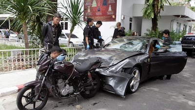 Policemen examine a damaged Ferrari at the home of the late Red Bull founder Chaleo Yoovidhaya in Bangkok, Thailand on September 3, 2012. His grandson Worayuth Yoovidhya allegedly killed a policeman while driving the car drunk, leaving a trail of debris all the way to the family home. Reuters
