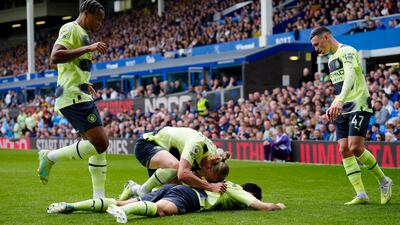 Manchester City's Ilkay Gundogan, on the ground, is congratulated by teammate Erling Haaland after scoring the opening goal. AP