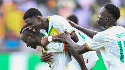 Senegal's midfielder Lamine Camara celebrates with teammates after scoring his team's third goal against Gambia. AFP