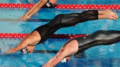 The American Michael Phelps, centre, and German Paul Biedermann dive from the starting blocks during the men's 200m freestyle event at the Foro Italica complex in Rome. Biedermann clocked 1:42.00 to set a new world record while Phelps took silver.