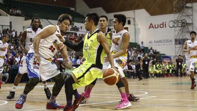 Billy Mamaril of GlobalPort Batang Pier dribbles against Beau Belga of Rain or Shine Elasto Painters in their PBA game in Dubai on Thursday. Antonie Robertson / The National