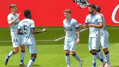 Atletico Madrid's Diego Costa, right, celebrates with teammates. AFP