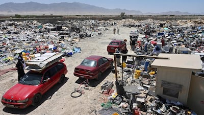 People select items at a recycling workshop near the Bagram Air Base. AFP