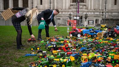 People add to the toy tractors left outside the venue of the National Farming Union's annual conference in London, in protest over how inheritance tax reforms could affect farmers’ families. Getty Images
