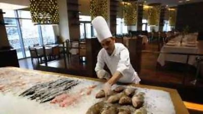 The chef de partie Tarek Abdelwkil prepares the fresh fish display at Al Sultan Brahim Beirut.