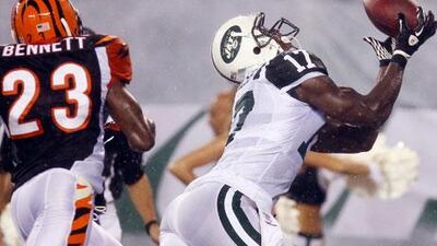 Plaxico Burress, right, is starting to catch on with his new team, the New York Jets.