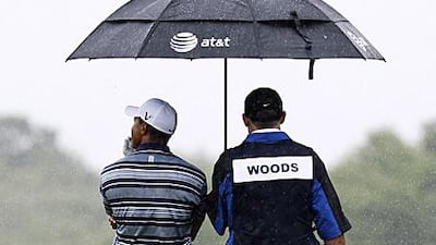 Fans wonder when Tiger Woods, left, will step out to play.
