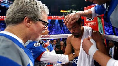 Trainer Freddie Roach, left, talks with Manny Pacquiao between rounds against Juan Manuel Marquez during their welterweight bout. Al Bello / Getty Images