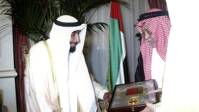 Sheikh Zayed receiving a medal from Abdul Ghani Ashi, then secretary general of the Arab Red Crescent Societies, for his charity and humanitarian efforts in July 2001 / WAM